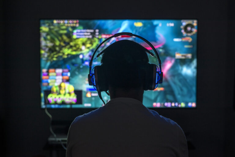 Young,Gamer,Playing,Video,Game,Wearing,Headphone.