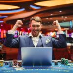 Portrait,Of,A,Happy,Young,Man,In,A,Suit,Using