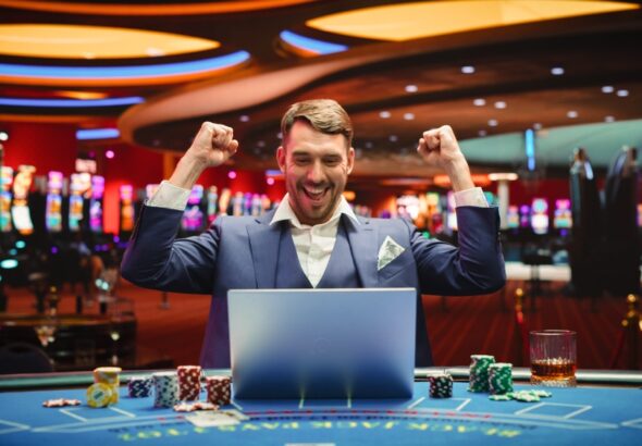 Portrait,Of,A,Happy,Young,Man,In,A,Suit,Using