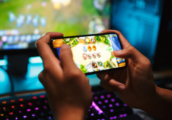 Hands,Of,Young,Gamer,Boy,Playing,Video,Games,On,Smartphone